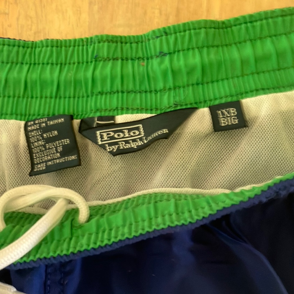 Polo swim trunk. Royal blue with green trim. White lining.